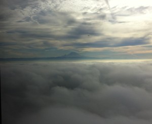 a view of Mt. Rainier across the cloudy sky from the Columbia Tower Club